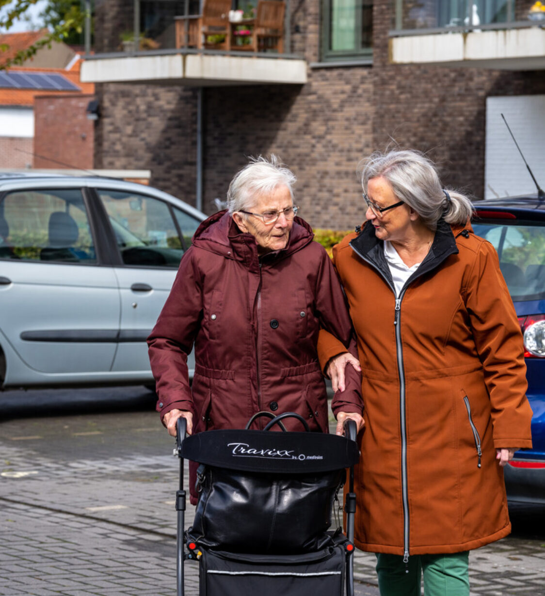 Een medewerker wandelt met een cliënt op straat